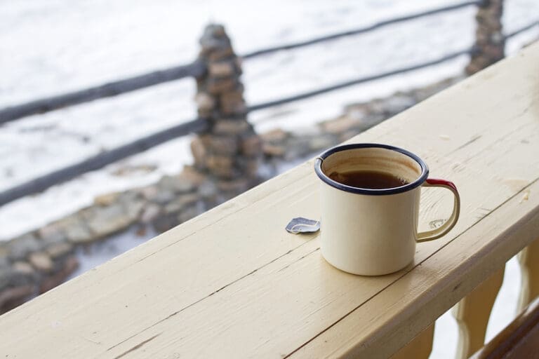 Extreme cold preparedness tips, featuring a coffee mug against a snowy backdrop