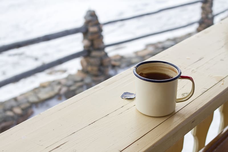 Extreme cold preparedness tips, featuring a coffee mug against a snowy backdrop