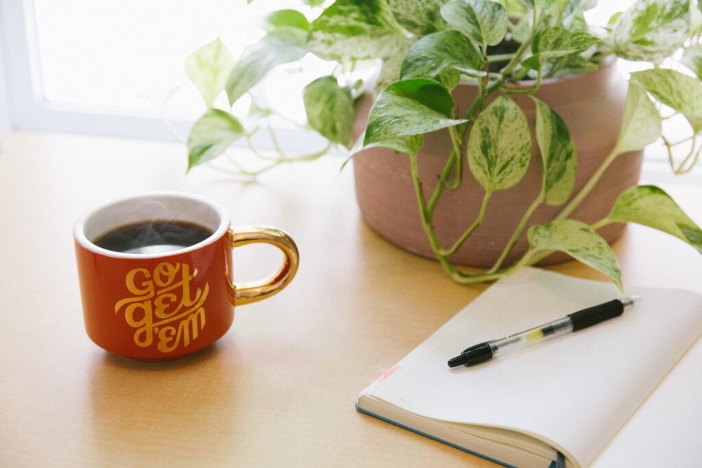 desk with coffee and a notebook