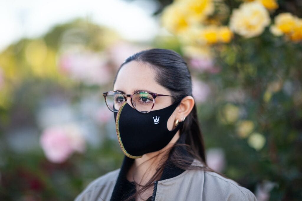 A woman wearing glasses and a mask.