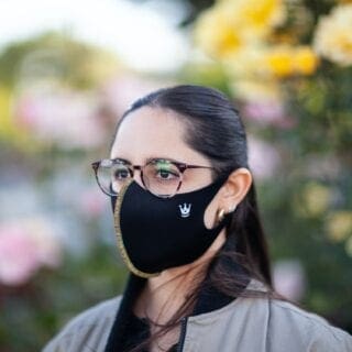 A woman wearing glasses and a mask.