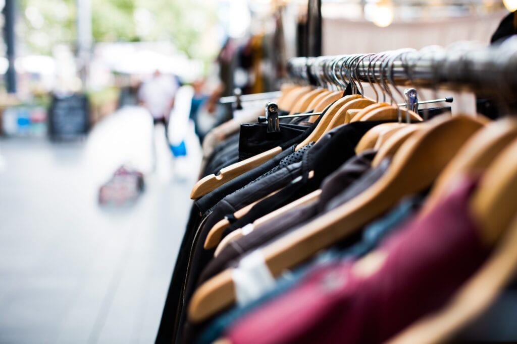 a rack of clothes outside of a store