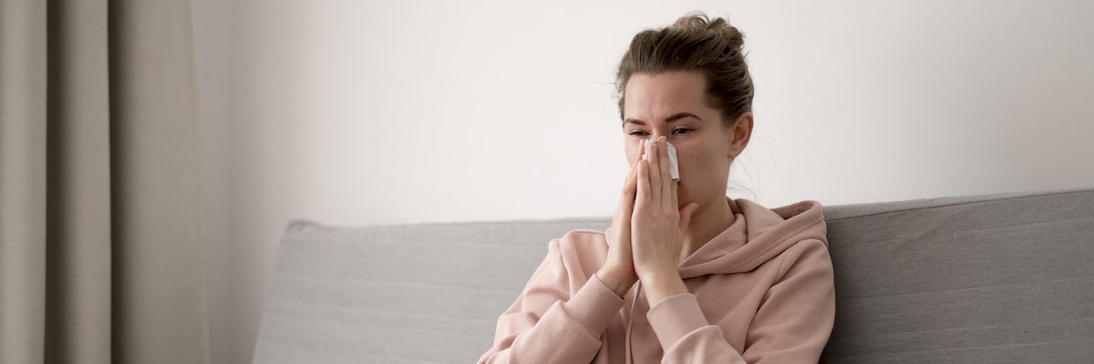 woman-indoors-blowing-her-nose