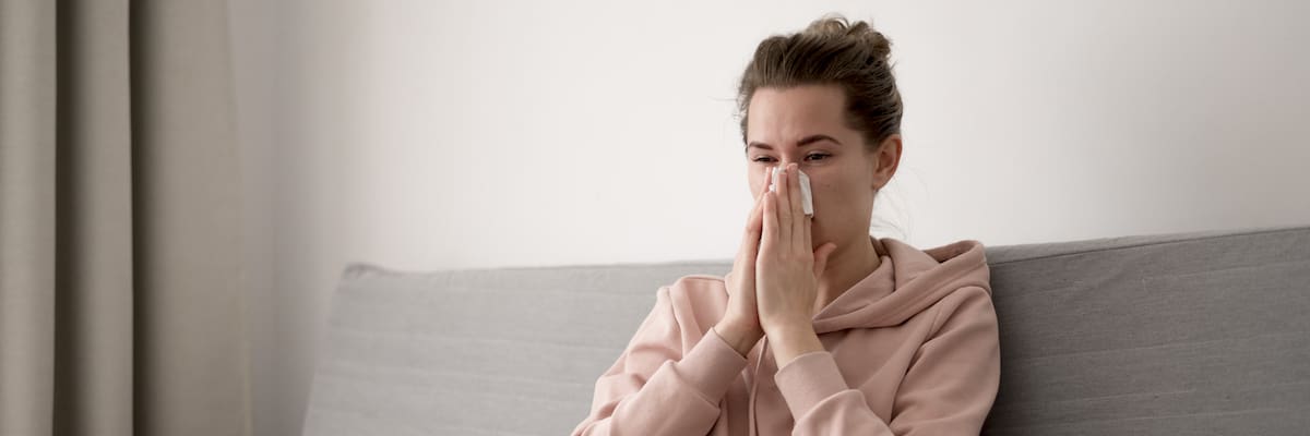 woman-indoors-blowing-her-nose