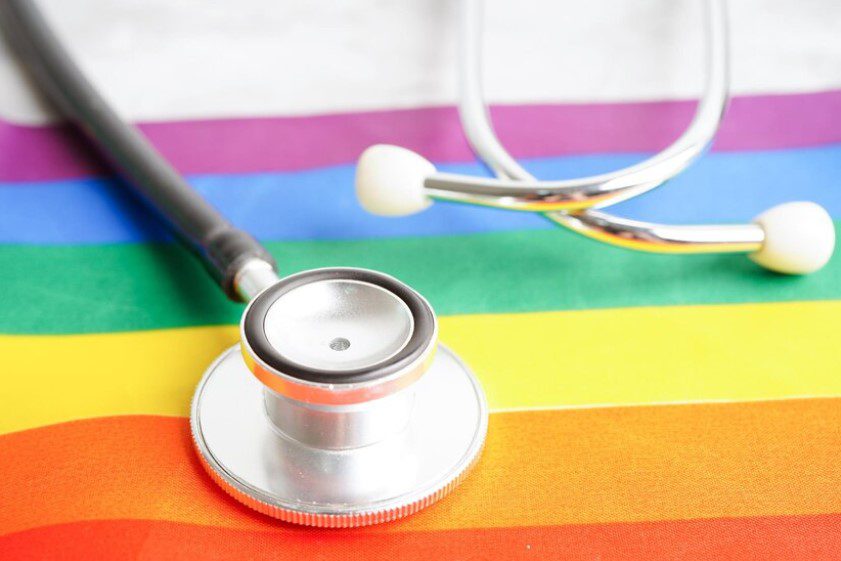 A stethoscope on top of a rainbow flag