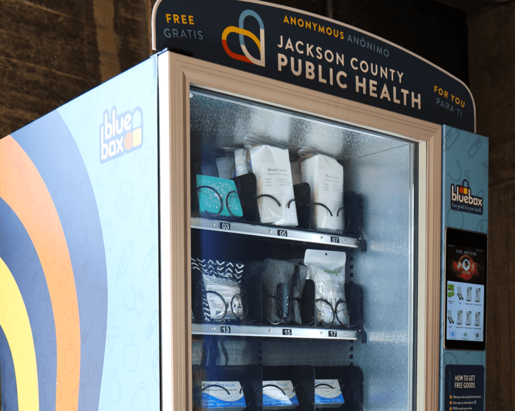 Vending machine stocked with first aid kits and other health supplies.